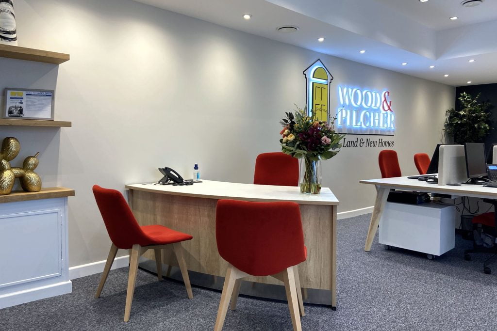 Reception desk and wall logo.