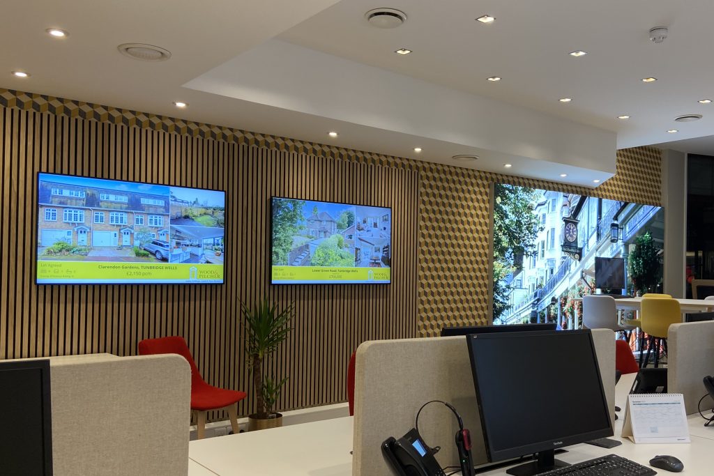 Large format illuminated wall image and property display screens.